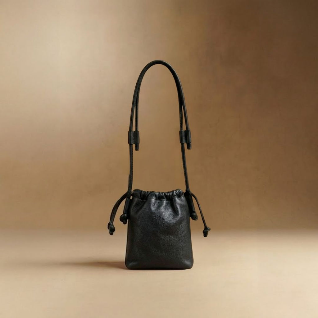 Eva Mini drawstring calf leather bag in black, front view — Biche Maison Dréan
