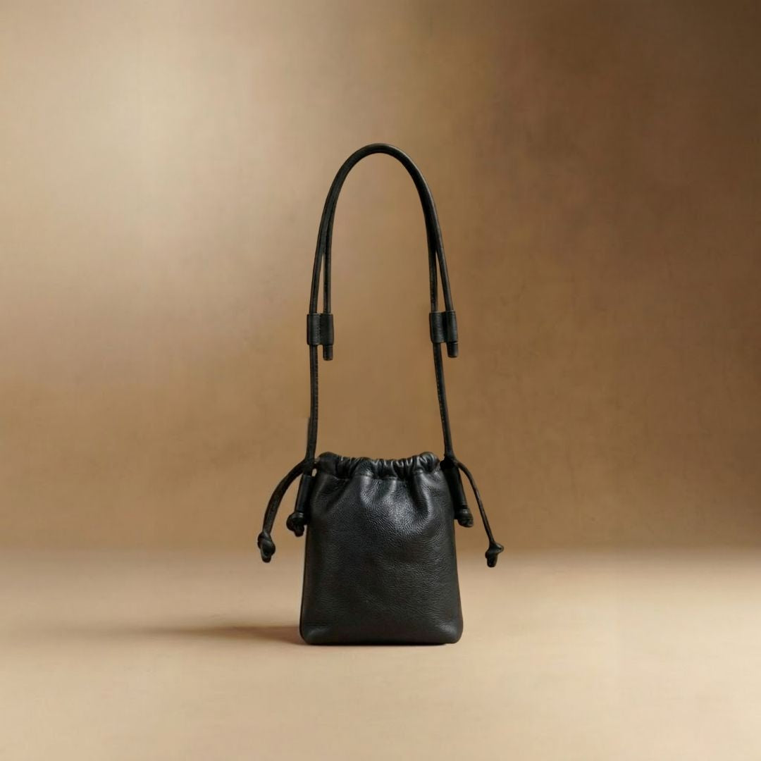 Eva Mini drawstring calf leather bag in black, front view — Biche Maison Dréan
