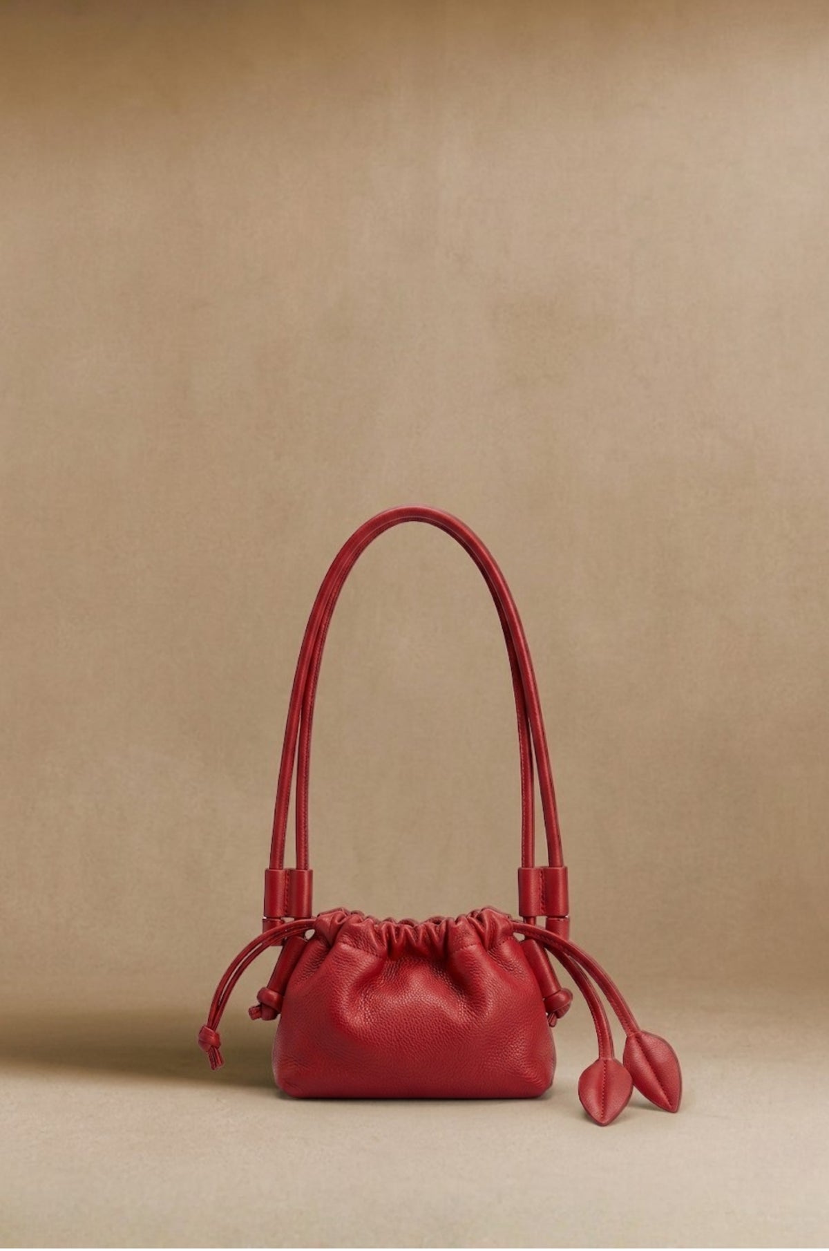 Eva Mini drawstring calf leather bag in red, front view — Biche Maison Dréan
