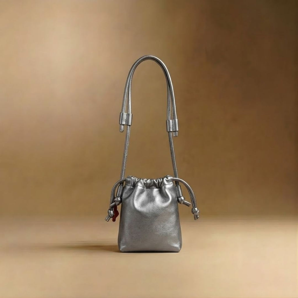 Eva Mini drawstring calf leather bag in plata, front view — Biche Maison Dréan
